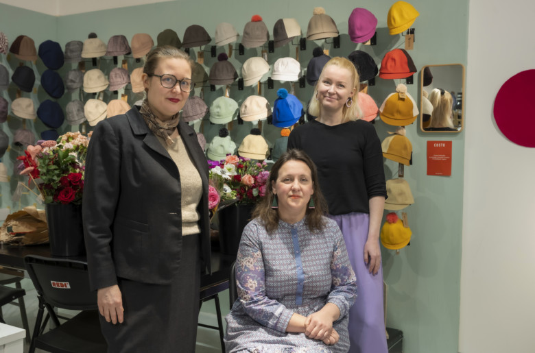 A photo of Rinna Saramäki, Tanja Linsiö, and Soile-Maria Linnemäki, posing together and smiling.